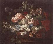 Still life of various flowers,in a wicker basket,upon a stone ledge